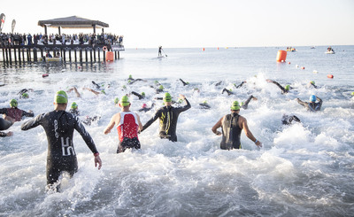 city street ocean swim triathletes water iron man triathlon competition beach 