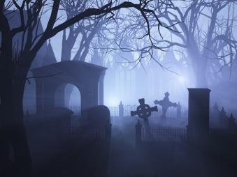 3D render depicting an overgrown neglected cemetaryin misty twilight.