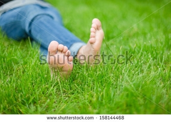 stock-photo-bare-feet-on-green-grass-copy-space-158144468