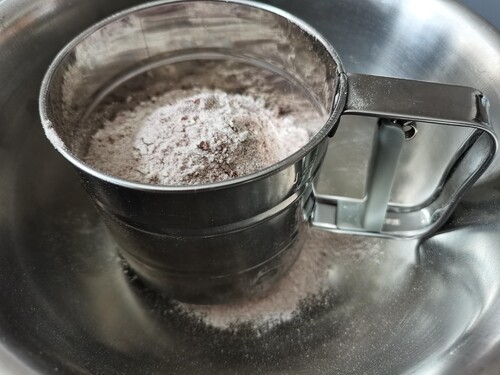 Tamiser le mélange farine, levure, cacao en poudre.
