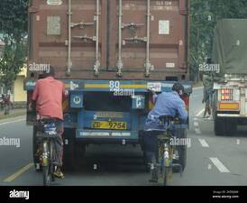 On route to Kigali, Rwanda 31st August 2022 Cyclists hanging on a truck ...