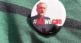 A supporter wears a campaign badge as British Labour Party politician Jeremy Corbyn arrives for a community meeting in north London August 9, 2015.