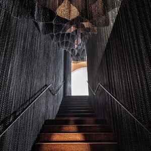 Kengo Kuma Hangs Glimmering Sheets of Metallic Chain Inside Gaudí's Casa Batlló