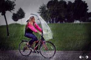 walking bicycle hands umbrella rainy city street road