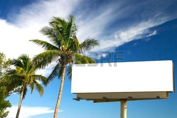 1342110-tropical-palm-trees-and-a-billboard-in-the-late-afternoon-sun-the-golden-hour-advertise-your