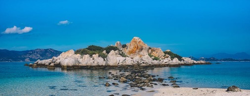 Rocky Island Surrounded by White Water