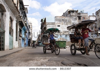 stock-photo-taxi-of-bicycles-and-tricycles-on-a-street-in-havana-cuba-8613307