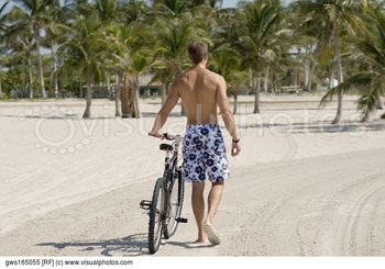 rear-view-of-a-young-man-walking-with-a-bicycle-on-the-beach