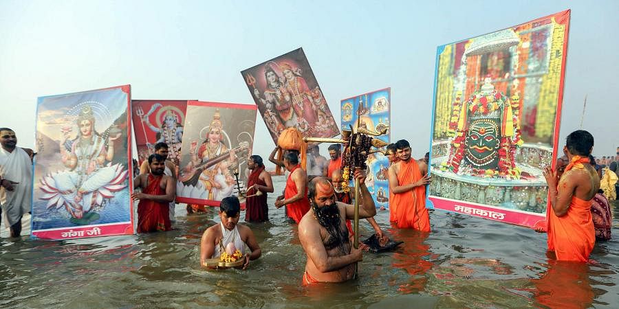 Sadhus offer prayers after taking a holy dip at Sangam confluence of River Ganga Yamuna and Saraswati on 'Mauni Amavasya' during the ongoing annual 'Magh Mela' festival in Prayagraj