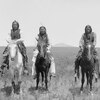 Three Comanche warriors on horseback, left, Frank Moetah. Photo by James Mooney, 1892