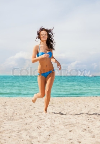 4494066-happy-smiling-woman-jogging-on-the-beach
