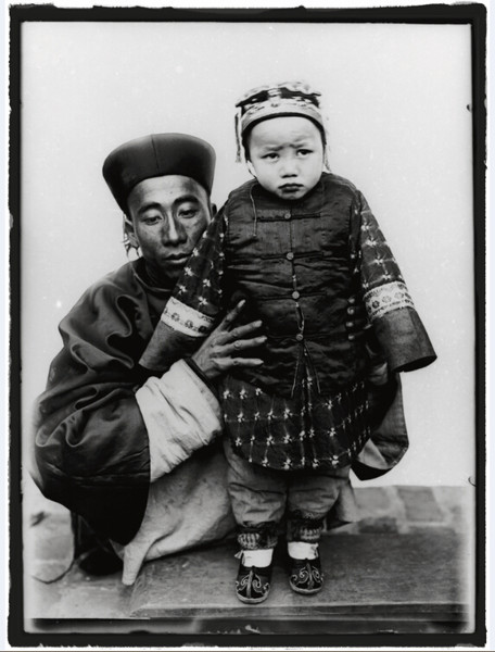 Portrait of a father wearing an official Qing Dynasty robe and holding his daughter