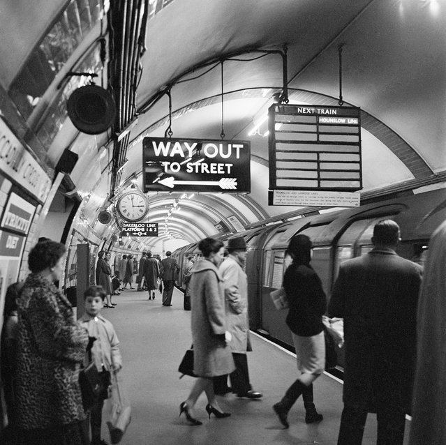 Piccadilly Circus Station, London, 1960-1965. Platform at Piccadilly Circus underground station showing people entering a Hounslow Line train, and the “Way Out” sign above. (Photo by English Heritage/Heritage Images/Getty Images)