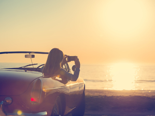 une dame en voiture qui prend des photos 