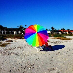 rainbow pinwheel beach sea sky 