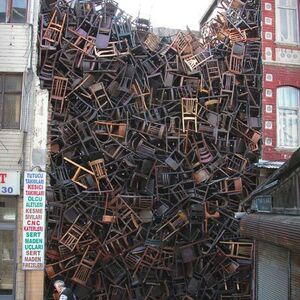 1550 Chairs Stacked Between Two City Build­ings” is an instal­la­tion by Doris Salcedo