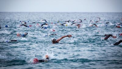 city street ocean swim triathletes water iron man triathlon competition beach 