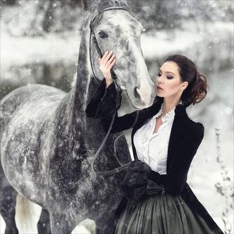 Victorian Noblewoman with her horse in the snow - For costume tutorials, clothing guide, fashion inspiration photo gallery, calendar of Steampunk events, & more, visit SteampunkFashionGuide.com