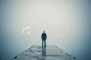 stock-photo-8421511-man-standing-at-end-of-dock-during-foggy-day