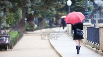 6965764-young-girl-behind-umbrella-while-it-s-raining