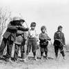 Sarcee children on Sarcee Reserve, Alberta, playing with bows and arrows. 1911. Photo by W.J. Oliver